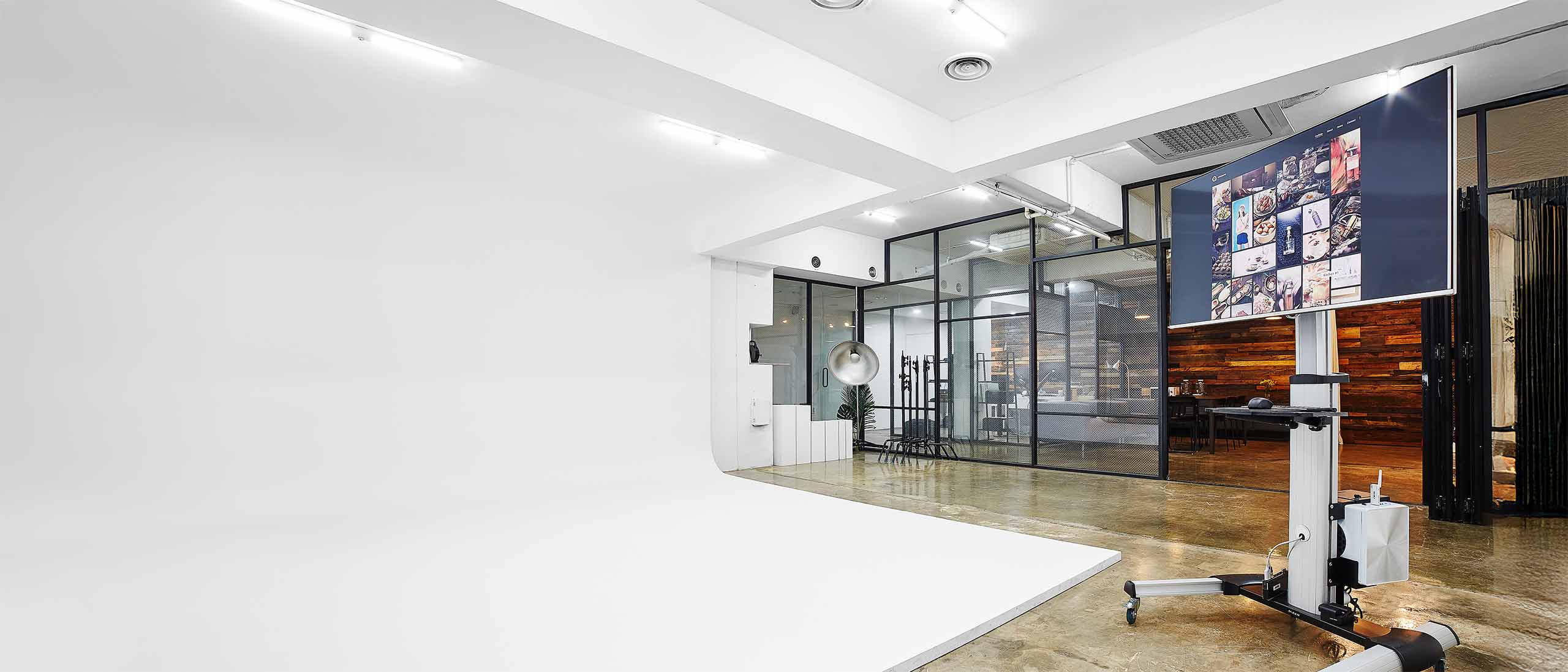 Interior view of AHNTONE photography studio showing cyclorama and workspace