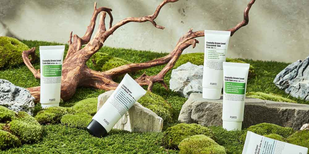Purito sunscreen on moss and stone