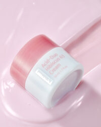 Single cream jar on glossy pink surface