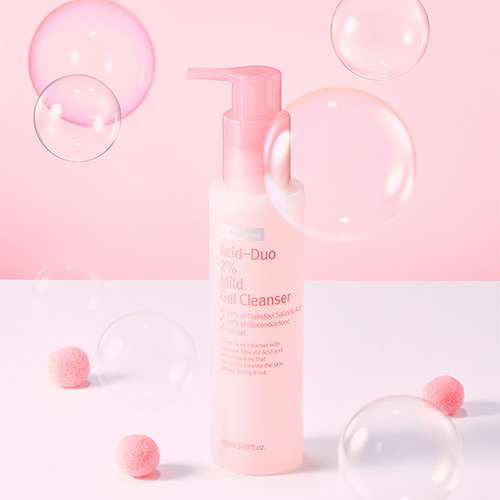 Pink cleanser bottle with floating bubbles and puff balls