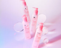 Four pink cleansing bottles with acrylic props