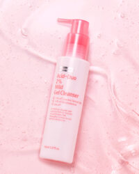 Mild gel cleanser bottle on pink textured background