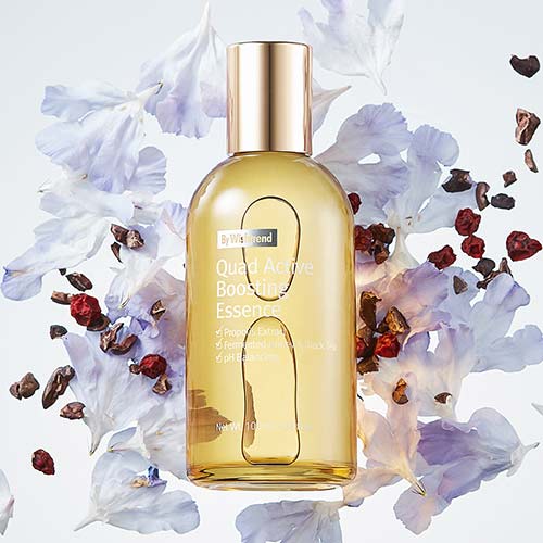 Essence bottle with floral and botanical elements on soft background