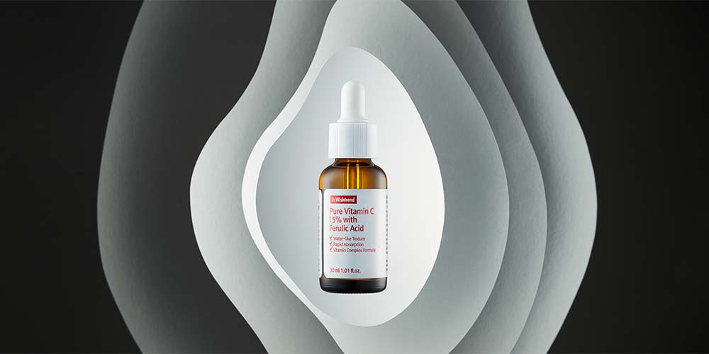 Pure Vitamin Serum styled with layered paper shapes