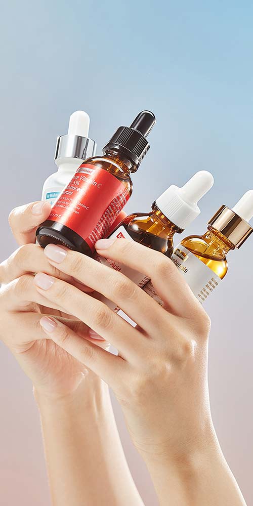 Assorted ByWishtrend Ampoules Held in Hands