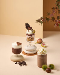 Three Godiva chocolate drinks with figs and chestnuts on beige background