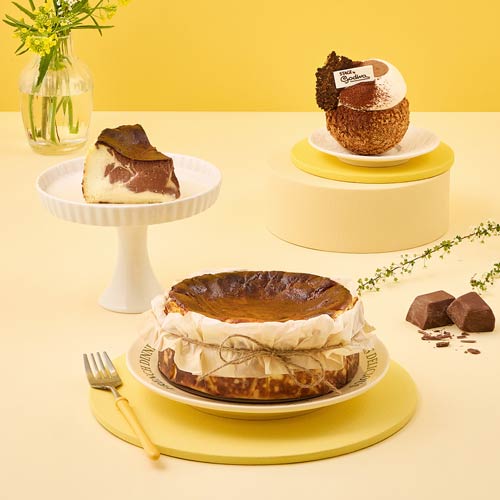 GODIVA Basque cheesecakes styled on yellow set