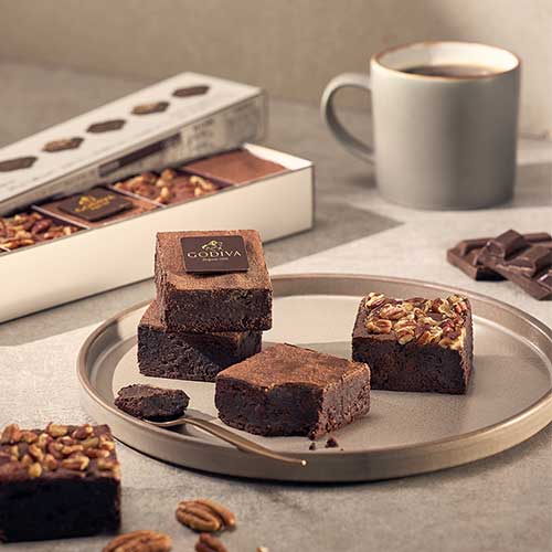 Chocolate brownies with Godiva branding and coffee