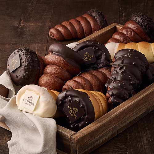 Chocolate-filled bread cones by Godiva in a wooden tray