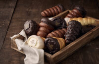 Chocolate-filled bread cones by Godiva in a wooden tray