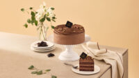 Chocolate cake with slice and plates in a studio setup Godiva cake photography by Studio AHNTONE