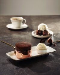 Studio image of chocolate soufflé and molten cake with coffee