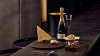 Luxury dessert and champagne styled on a dark minimal counter