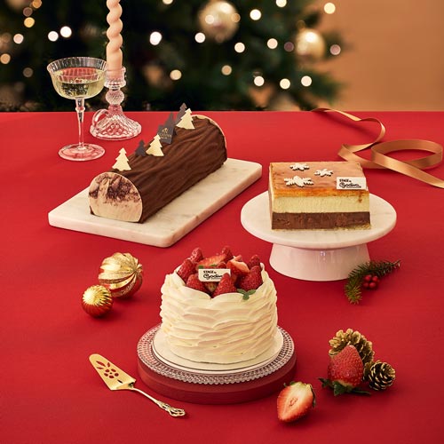 Holiday cakes with Christmas decoration on red table