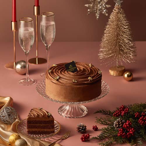 Festive chocolate cake styling with candles and holiday decor