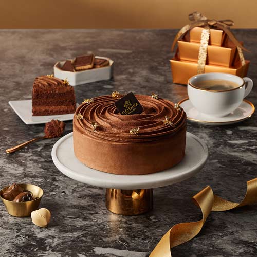 Chocolate cake, coffee, and gift box styled for holiday season