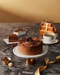 Chocolate cake, coffee, and gift box styled for holiday season