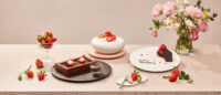 Godiva dessert plate with strawberry styling on beige table