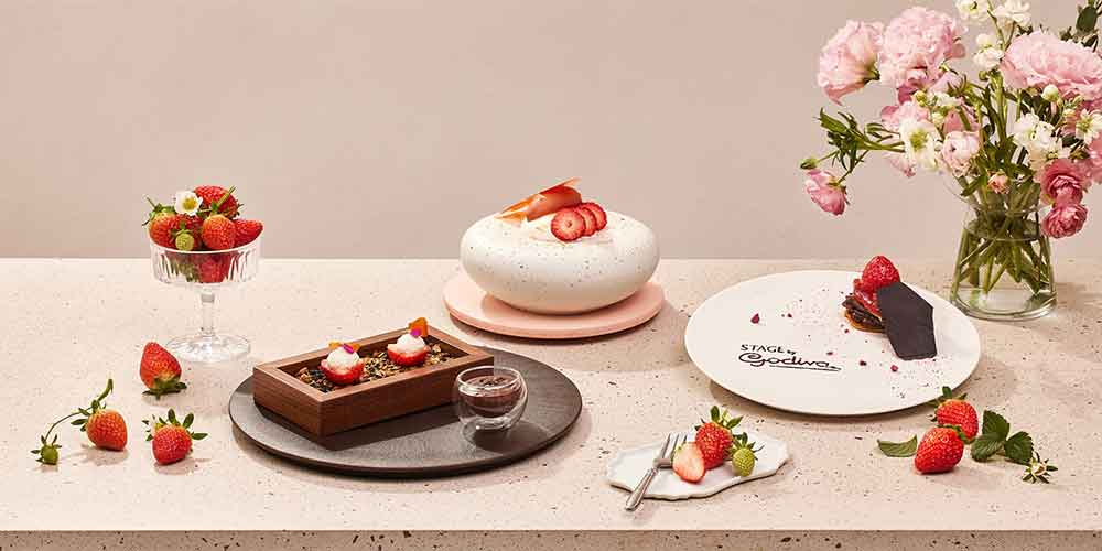 Godiva dessert plate with strawberry styling on beige table