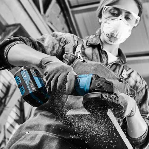 Woman grinding wood with power tool