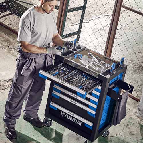 Mechanic preparing tools next to tool cart