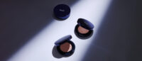 클레어스 쿠션 제품이 드라마틱한 조명 아래 놓인 모습 Klairs cushion compacts under dramatic spotlight