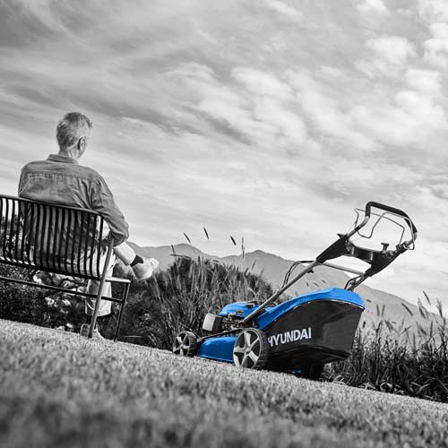 Man Resting After Mowing – Lawn Equipment Scene