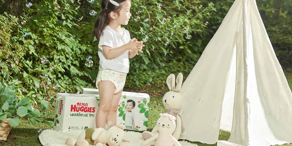 Girl Playing with Bubbles in Nature with Huggies Diaper