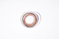 렌즈미 브라운 컬러 콘택트렌즈가 흰 배경 위에 놓인 모습 Image of a single LensMe brown color contact lens centered on a white background