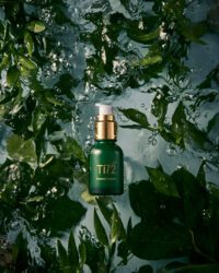 휴메디컬 Ti72 세럼이 물 위에 떠 있는 듯한 장면, 녹색 잎과 어우러진 고급스러운 연출 Humedical Ti72 serum captured floating in water, surrounded by lush green leaves for a luxurious look