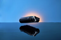 푸른 배경과 물 위 반사로 연출된 아이로드 X10 프로 블랙박스 광고 사진 IROAD X10 Pro dashcam advertising photo with blue water reflection